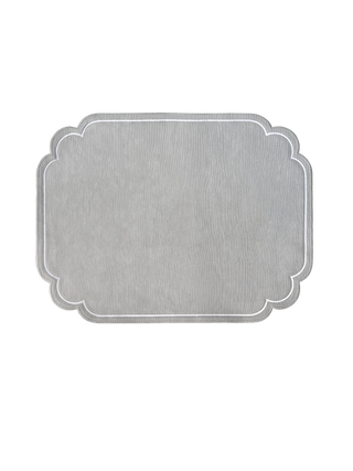 Gray placemat with scalloped edge on a white background